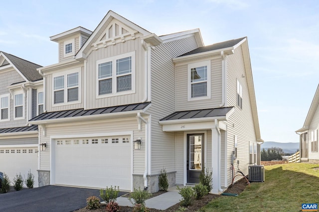 view of front facade featuring cooling unit, a front yard, and a garage