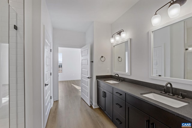 bathroom with a shower, vanity, and hardwood / wood-style flooring