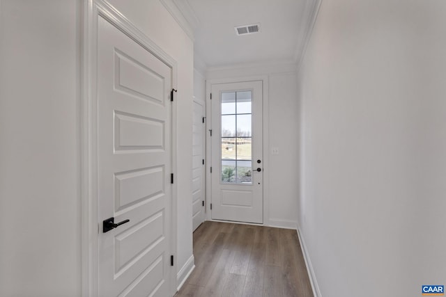 doorway featuring light hardwood / wood-style floors and crown molding