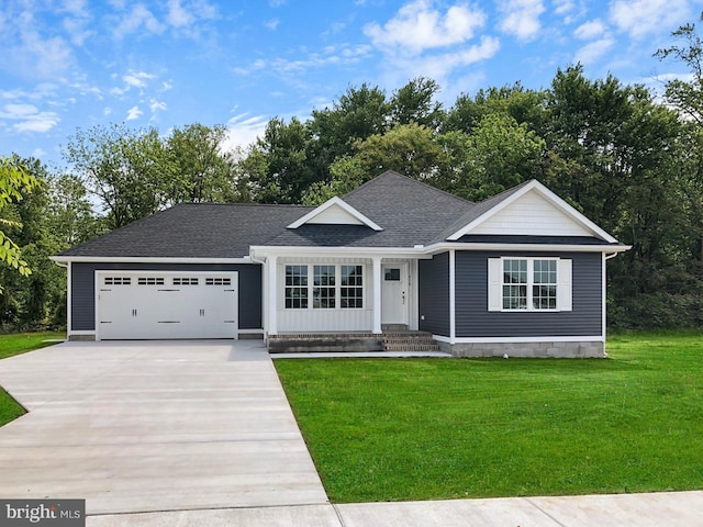 view of front of house with a front yard and a garage