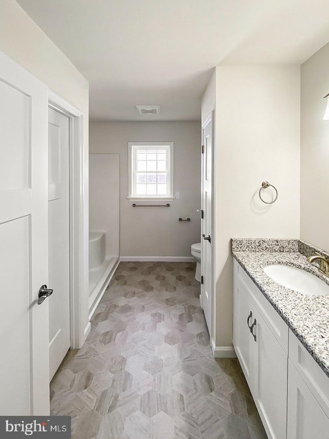 bathroom featuring vanity and toilet