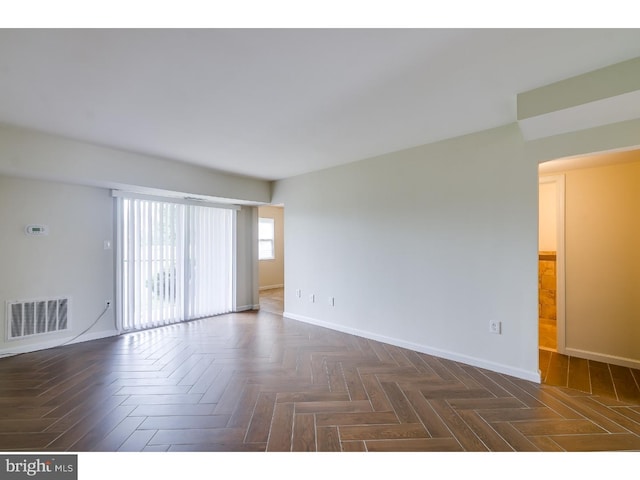 empty room featuring dark parquet flooring