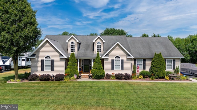 cape cod-style house with a front yard