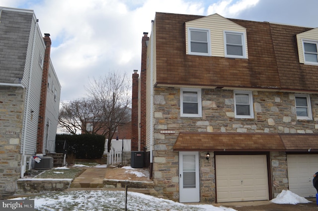 exterior space featuring a garage and central AC unit