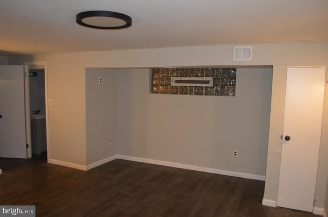 basement with dark hardwood / wood-style flooring