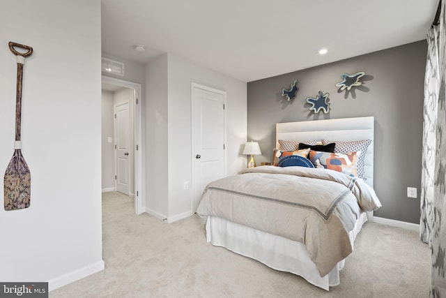 bedroom with light colored carpet