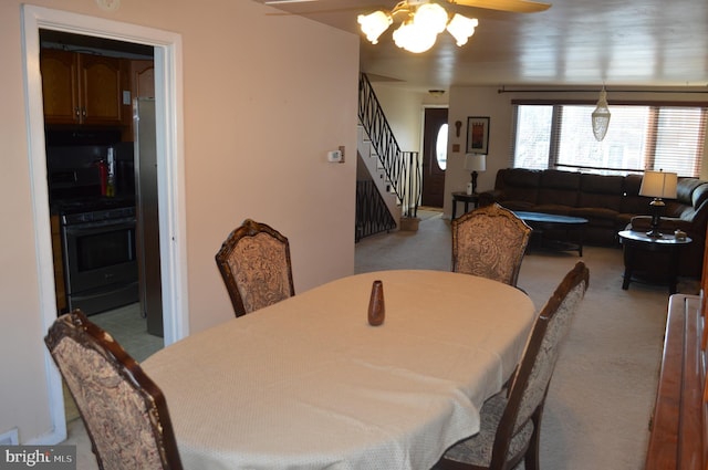 carpeted dining room with an inviting chandelier