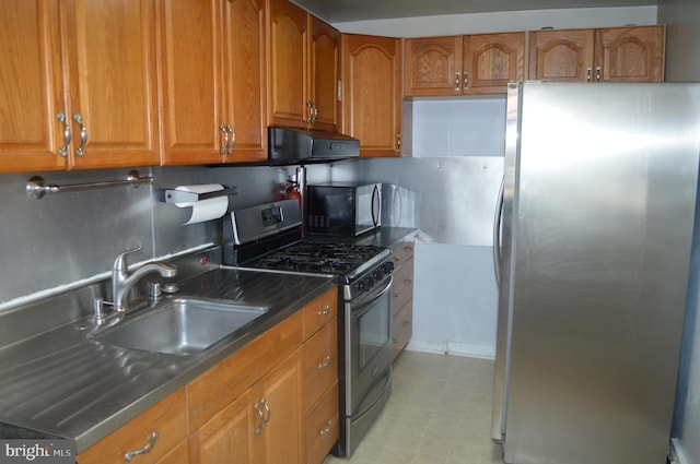 kitchen featuring appliances with stainless steel finishes, tasteful backsplash, and sink