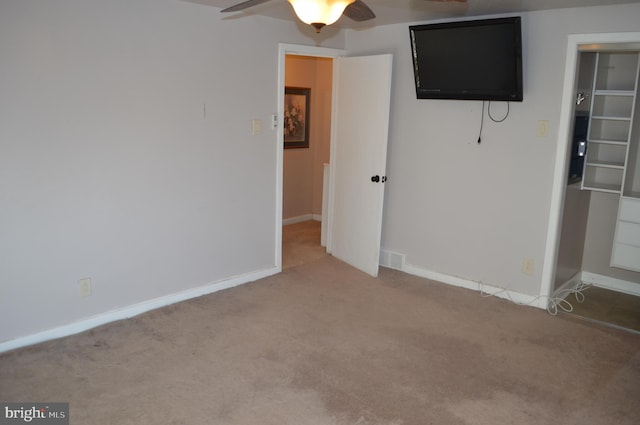 unfurnished bedroom featuring ceiling fan, a closet, and carpet flooring