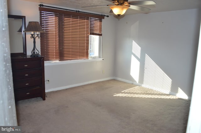 interior space with ceiling fan and light carpet