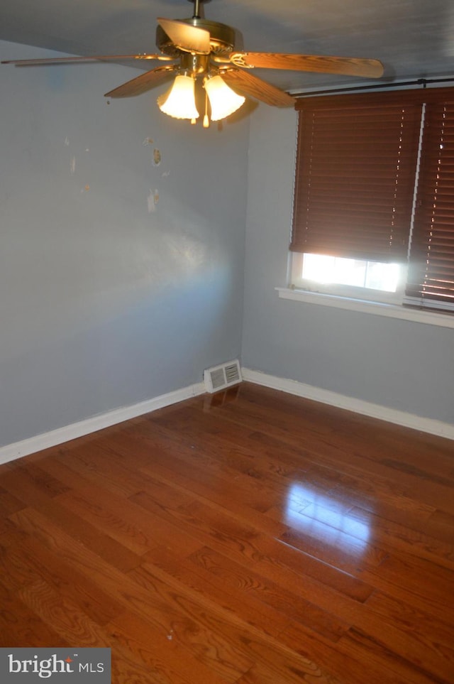 empty room featuring ceiling fan and hardwood / wood-style floors