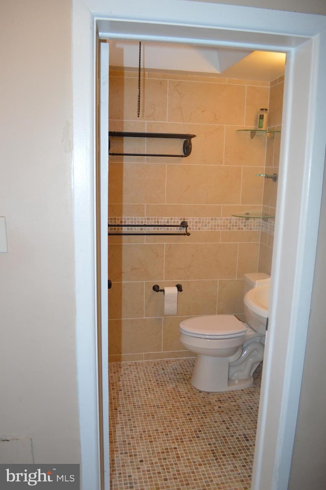 bathroom with toilet and tile patterned floors