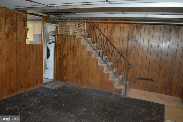 basement with washer / dryer and wood walls