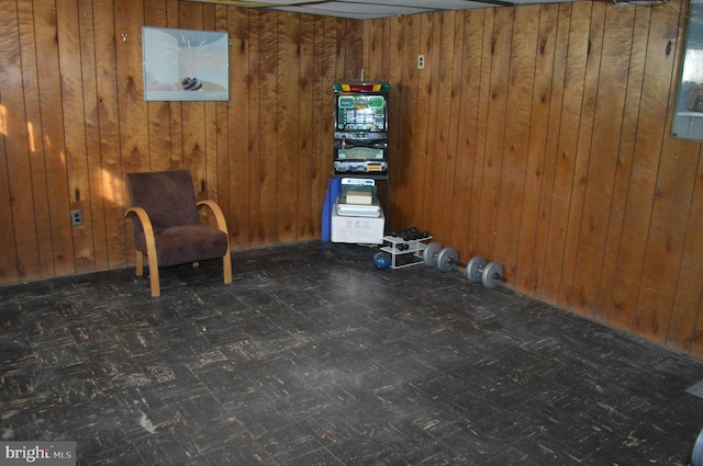 unfurnished room featuring wood walls