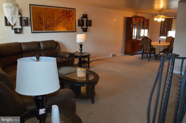 carpeted living room with ceiling fan