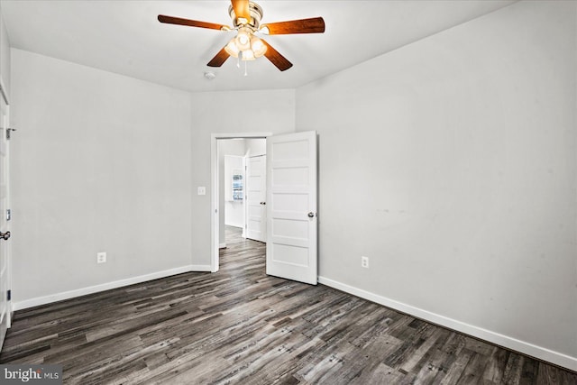 empty room with ceiling fan and dark hardwood / wood-style floors