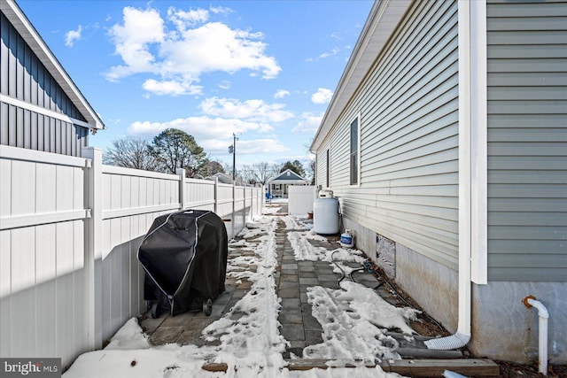 snow covered patio with area for grilling