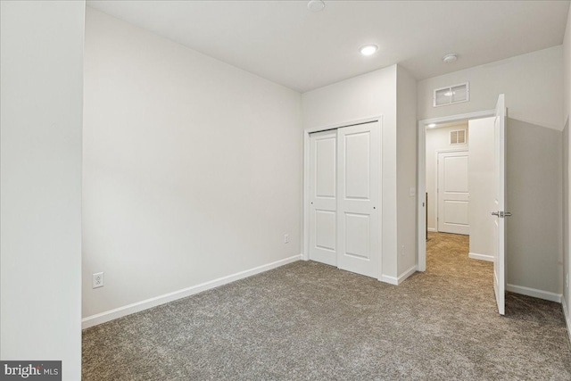 unfurnished bedroom with carpet floors and a closet