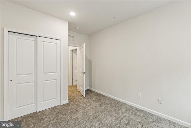 unfurnished bedroom with carpet floors and a closet