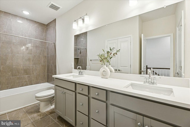 full bathroom featuring vanity, toilet, and tiled shower / bath