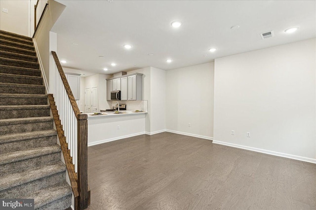 unfurnished living room featuring dark hardwood / wood-style floors