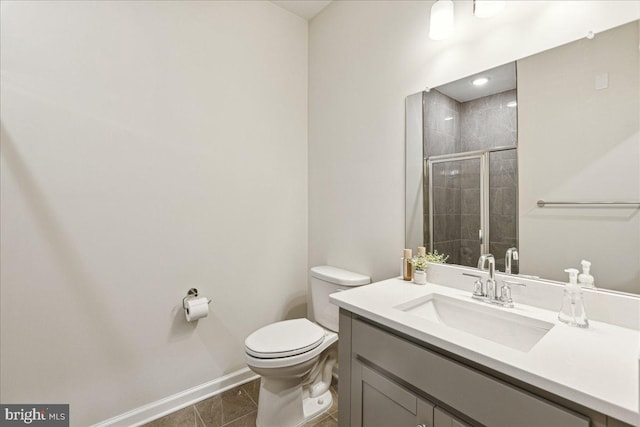 bathroom featuring tile patterned flooring, vanity, toilet, and an enclosed shower