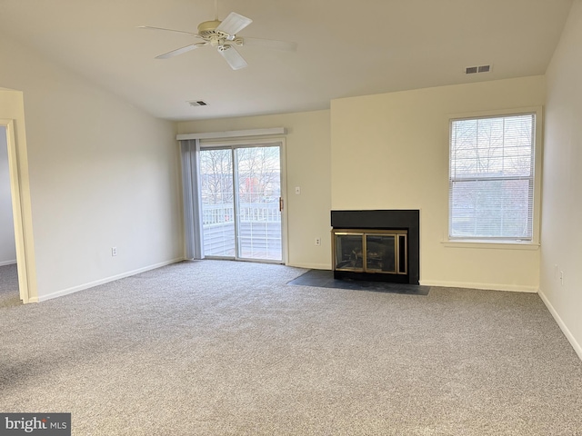 unfurnished living room with carpet flooring and ceiling fan