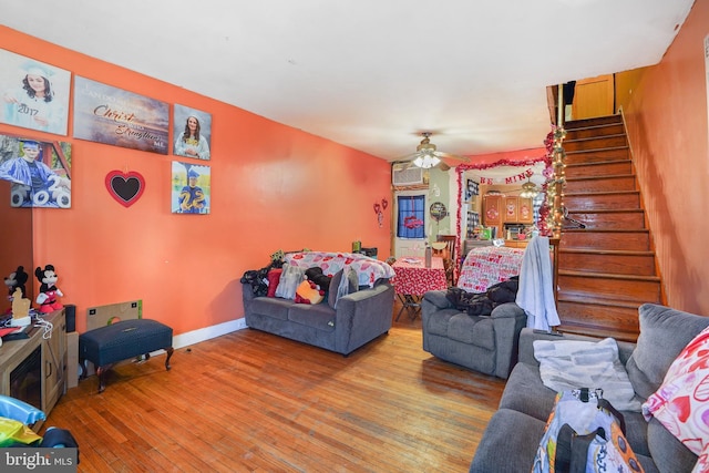 living room featuring ceiling fan and hardwood / wood-style floors