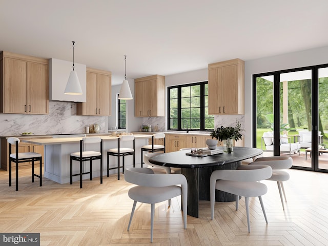 dining space featuring light parquet flooring and a wealth of natural light