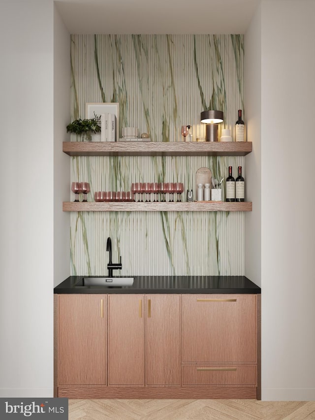 bar with sink and light brown cabinets