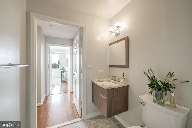 bathroom featuring tile patterned floors, vanity, and toilet