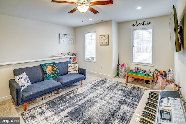 living room featuring ceiling fan and carpet flooring