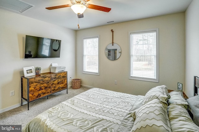 carpeted bedroom with multiple windows and ceiling fan