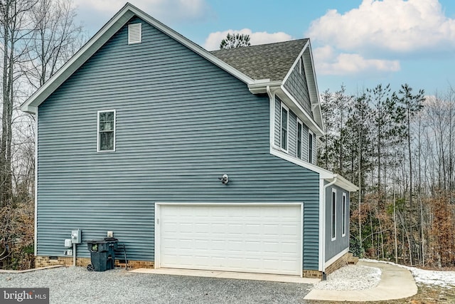 view of side of home with a garage