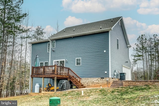 back of property with a garage, a wooden deck, and a lawn