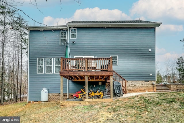 back of house with a wooden deck and a yard