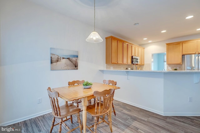 dining area with hardwood / wood-style flooring