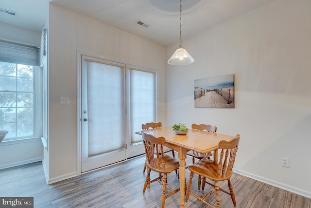 dining area featuring light hardwood / wood-style flooring and a healthy amount of sunlight