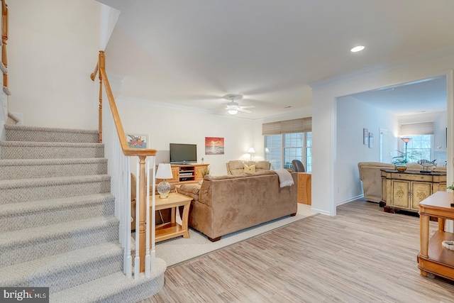 living room with ceiling fan, light hardwood / wood-style floors, crown molding, and a healthy amount of sunlight