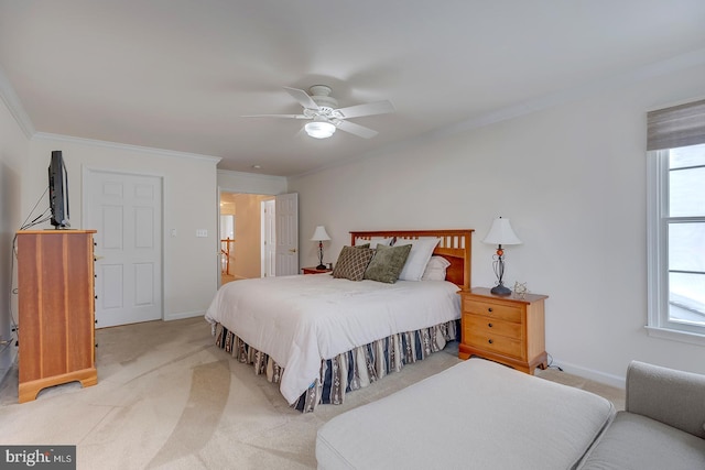 carpeted bedroom with ceiling fan, ornamental molding, and multiple windows