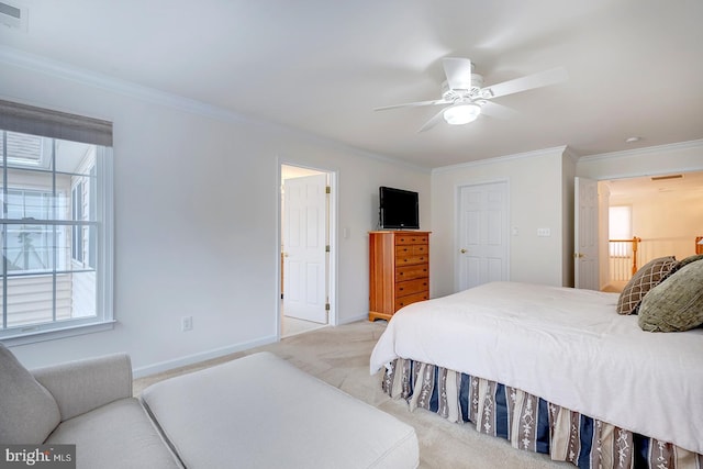 carpeted bedroom with ceiling fan and crown molding