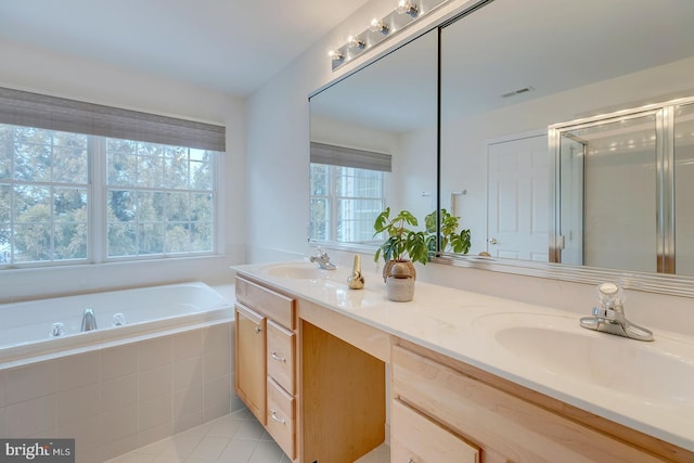 bathroom featuring tile patterned floors, vanity, and plus walk in shower