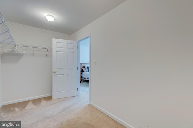 spacious closet with light colored carpet