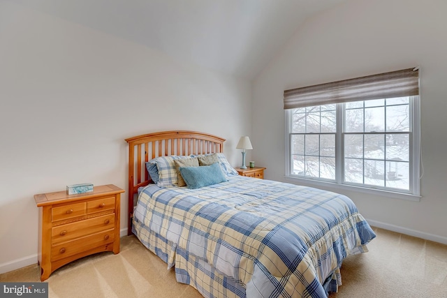 carpeted bedroom with lofted ceiling