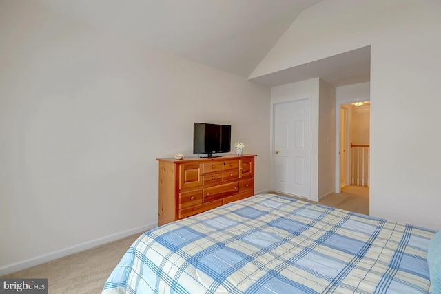 bedroom featuring lofted ceiling and light colored carpet