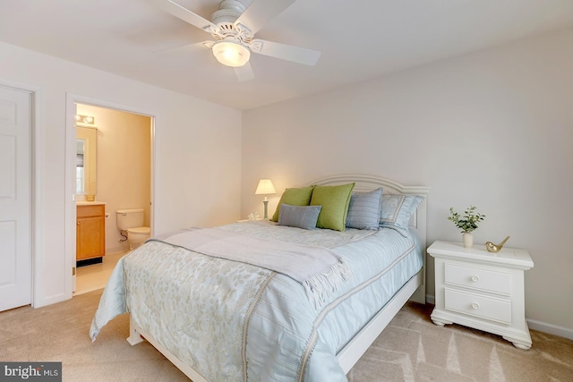 bedroom with light carpet, ceiling fan, and ensuite bathroom