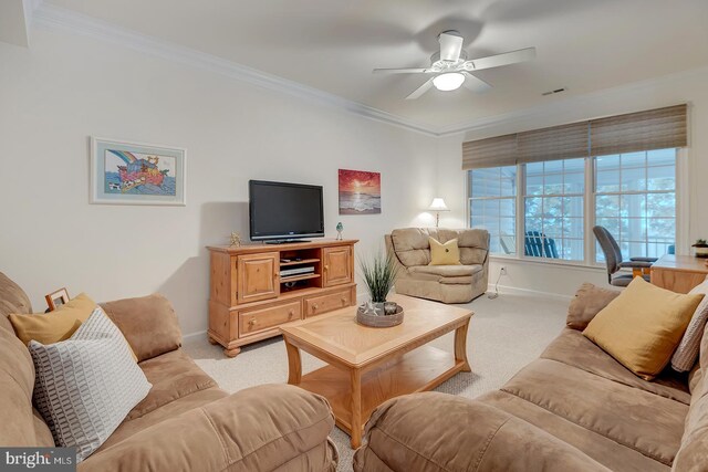 carpeted living room featuring ceiling fan and ornamental molding