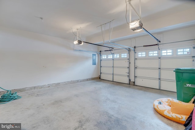 garage with a garage door opener and electric panel