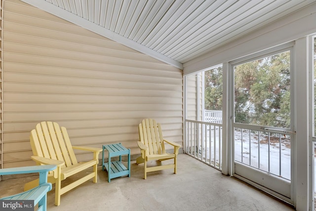 sunroom featuring vaulted ceiling