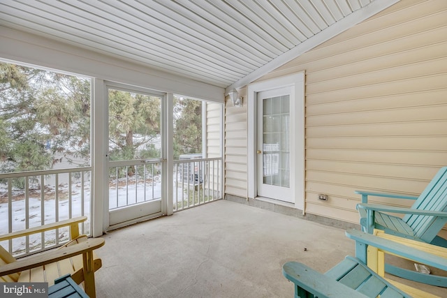 sunroom / solarium with vaulted ceiling and a wealth of natural light